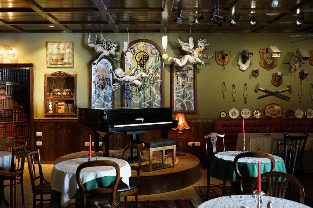 Banksy Walled Off Hotel piano bar interior, Bethlehem, Palestine — photographed by GraffitiStreet, 2017