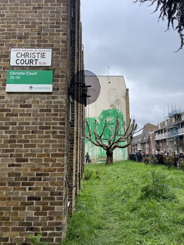 Stencilled figure with pressure hose in Banksy’s Finsbury Park mural