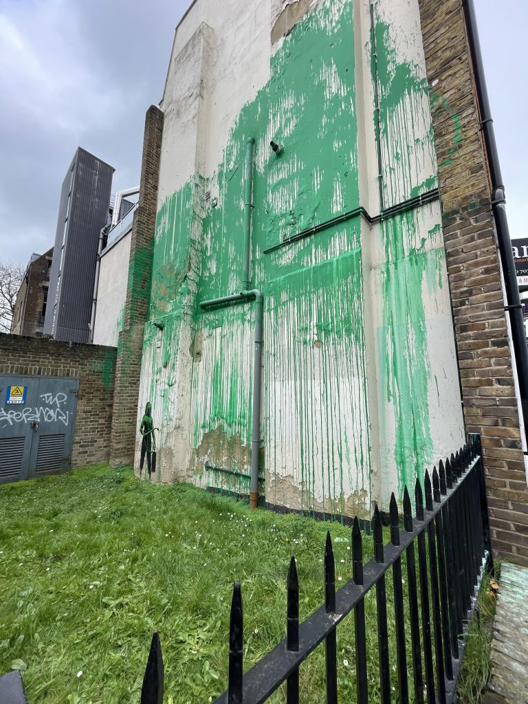 Green painted canopy of Banksy’s Hornsey Road tree mural