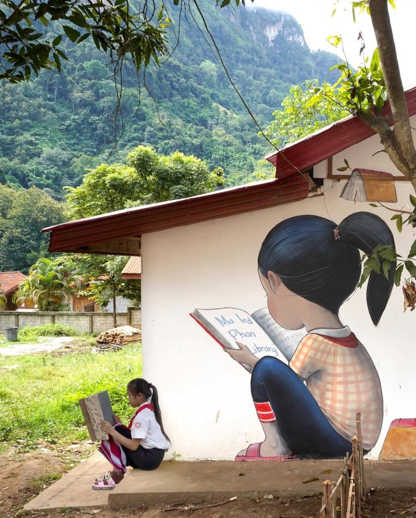 Detail of Seth Globepainter Tree of Books mural showing reading child