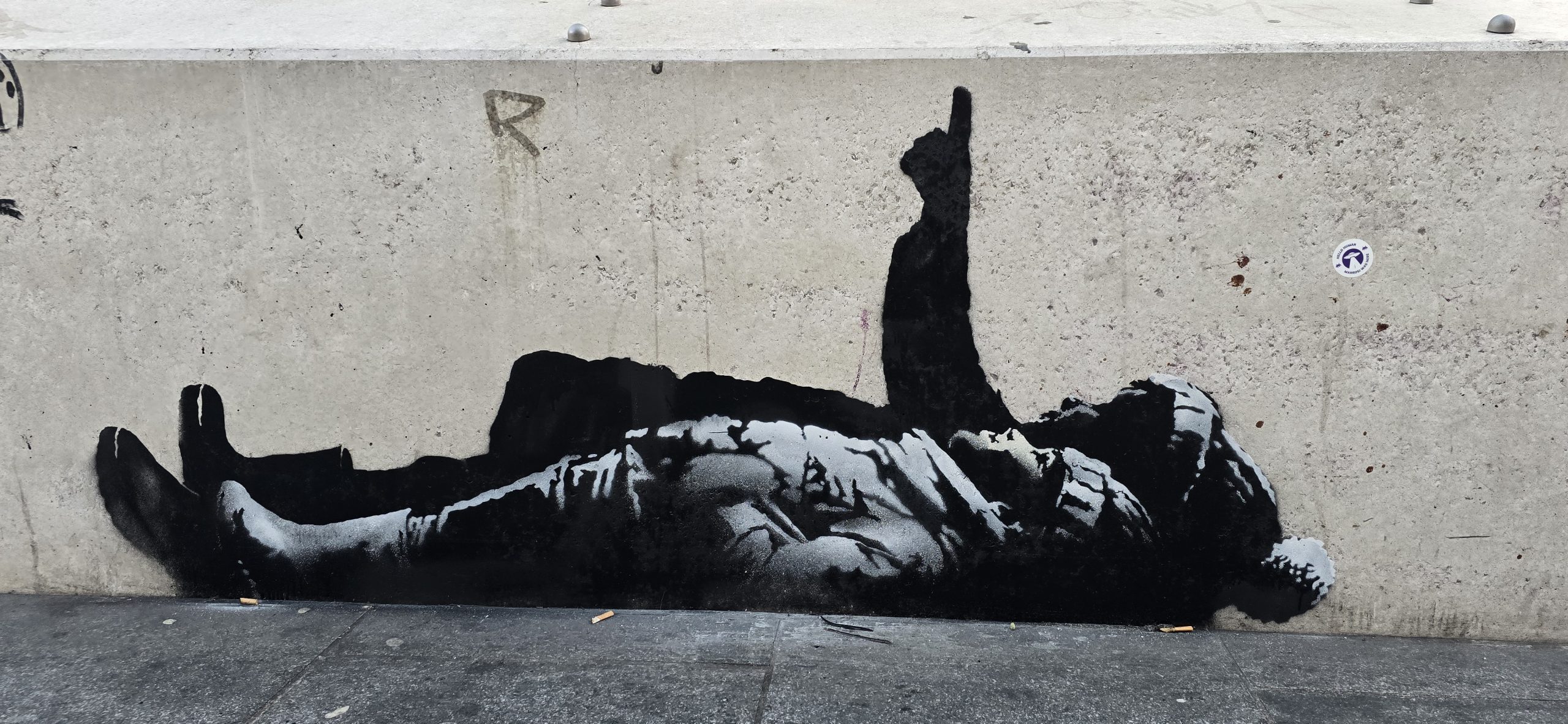 Banksy Christmas mural London showing children lying on pavement