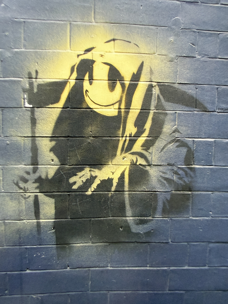 Grin Reaper appeared as a street piece on Old Street, Shoreditch, London 2004.