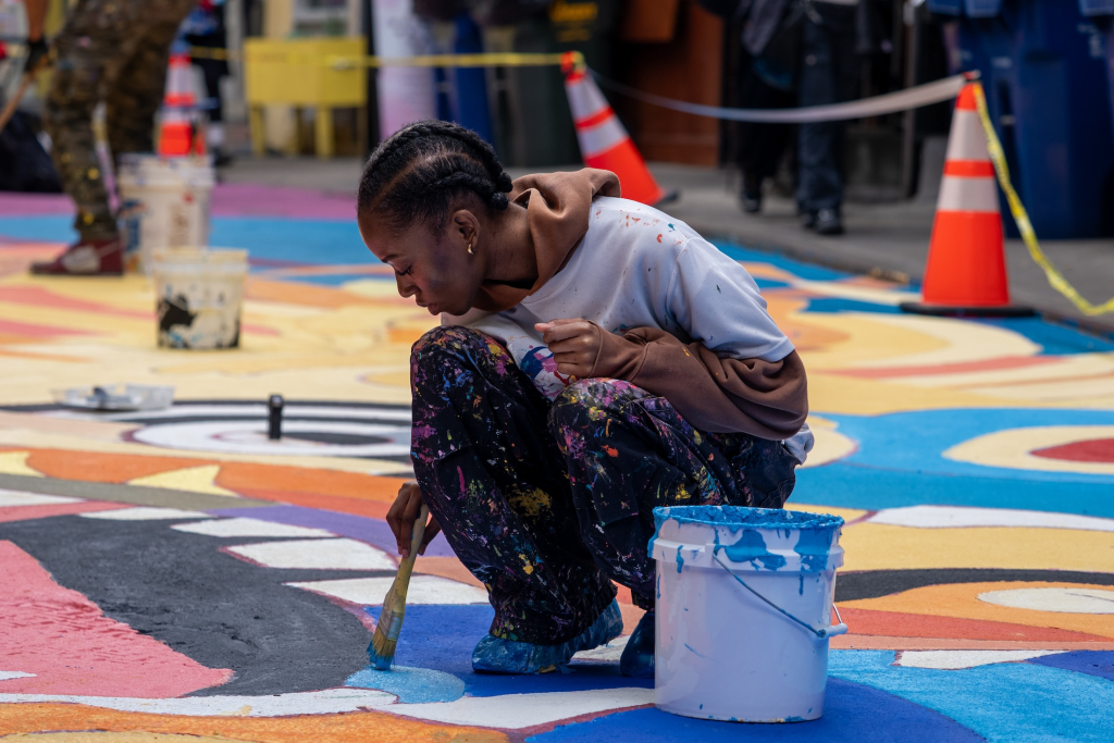 Community volunteers painting the Doyers Street mural