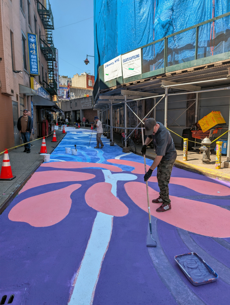 SMOE Studio painting the Doyers Street mural