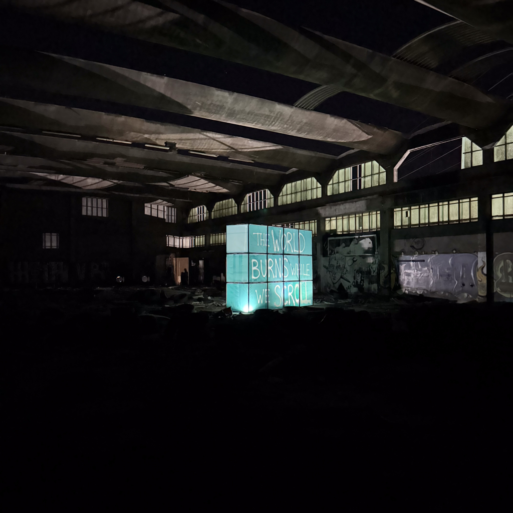 Ricardo Romero’s illuminated image of Soviet children glowing inside a dark abandoned industrial interior.